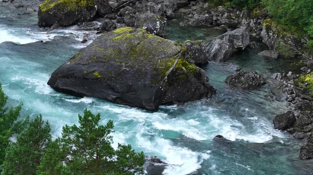 hovering drone flight, close view above arctic wild river with rocks, waterfall, rapids in wilderness in nordic Norway. Romsdalen valley, amazing wild nature, beautiful environment. Big boulders in th