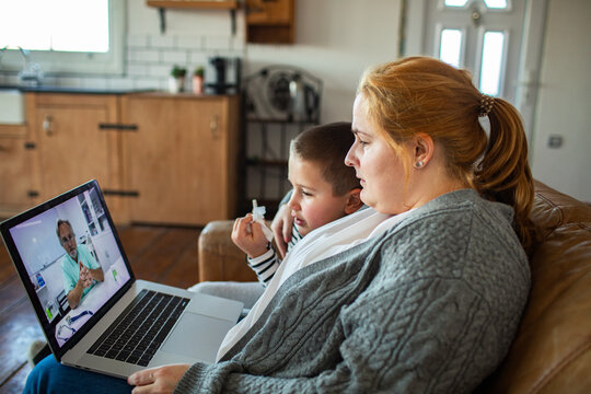 Mother and son telehealth video consultation at home