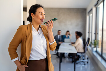 Smiling successful business woman, freelancer, coworker female leader using digital device, phone