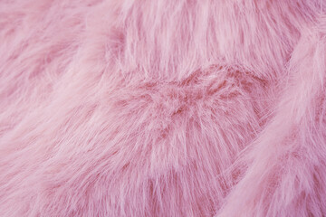Fototapeta premium A luxurious soft pastel pink faux fur fabric material background texture close up surface detail