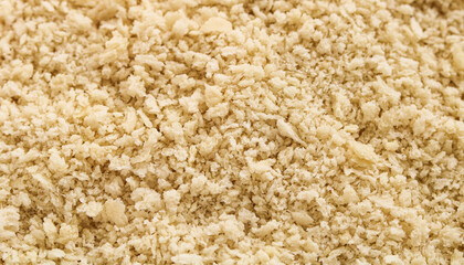 Closeup textured background of light bread crumbs, specifically the Panko variety.