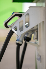 Electric vehicle charging connector at a station