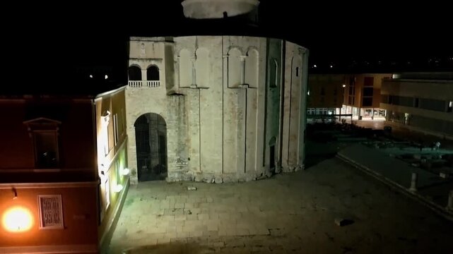 Aerial drone night view of the iconic circular Church of St. Donatus, one of Zadar s most famous pre Romanesque landmarks