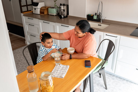 Mother and son sharing breakfast time at home