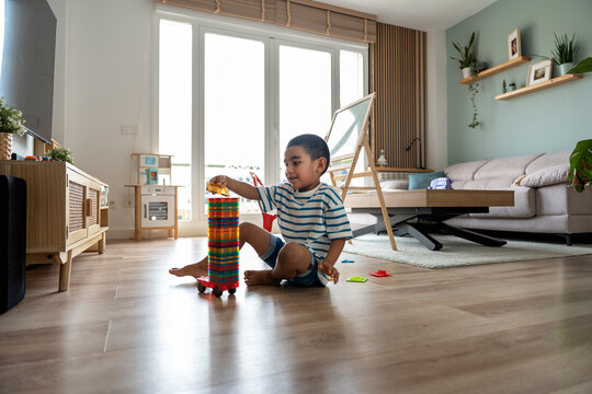 Boy playing with blocks in a cozy living room