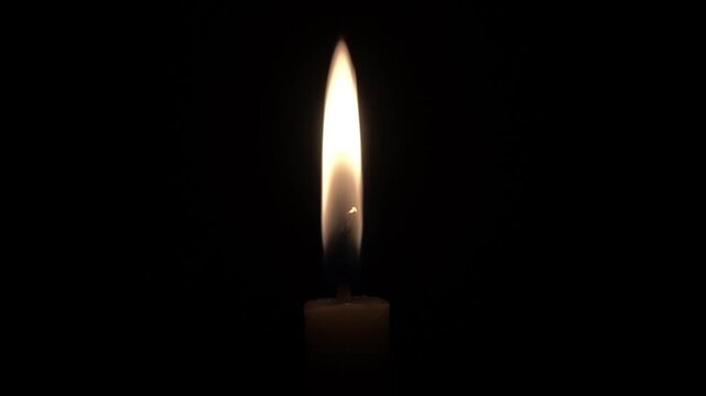 a video showing the light from a candle being lit as lighting due to the pitch black conditions caused by a power outage in the neighborhood at night
