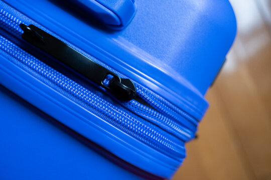 Close-up of blue suitcase with durable zipper detail