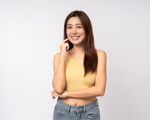 Beautiful young asian woman in yellow shirt. Charming female lady standing pose thinking on...