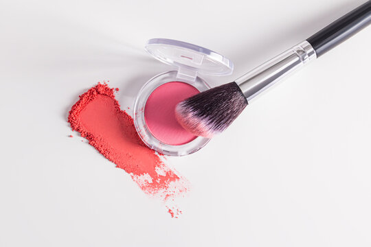 Professional makeup brush and blush on white background