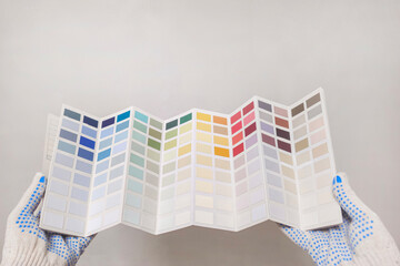 The person is wearing gloves and he is a house painter.