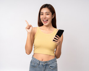 Pretty young asian woman using cellphone smartphone standing on isolated white background. Happy Excited Beautiful young asian shopping online payment with mobile phone. Holding smartphone