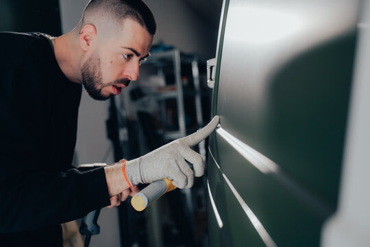 Custom car wrapping process in auto workshop