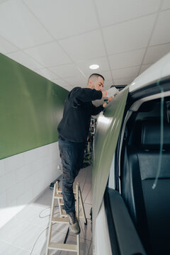 Professional technician in vehicle customization workshop