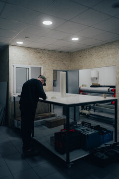 Technician in automotive workshop preparing for branding