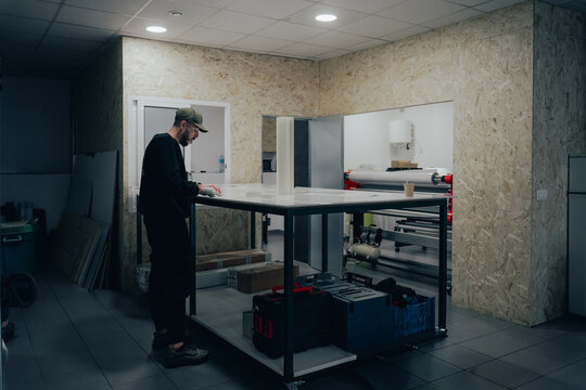 Technician in automotive workshop focusing on vehicle branding