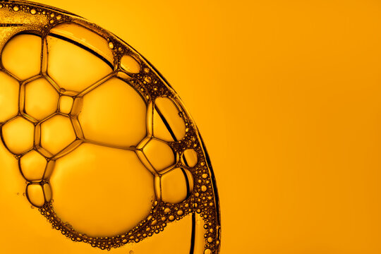 Macro view of intricate soap bubbles with orange hue