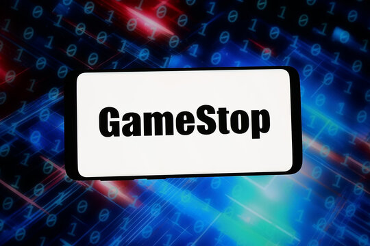 Stuttgart, Germany - 02-09-2026: In this photo illustration, the logo of US video game retail company GameStop Corp. is displayed on a smartphone in front of abstract background on computer screen.