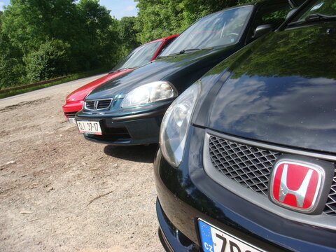  Lineup of Honda cars including Civic EG EK EP and Prelude parked near forest. Japanese tuning enthusiasts meet in Czech Republic.