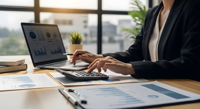 A professional working on financial analysis, using calculator and laptop