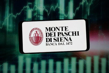 Fototapeta premium Stuttgart, Germany - 02-09-2026: In this photo illustration, the logo of Banca Monte dei Paschi di Siena S.p.A. (MPS) is displayed on a smartphone in front of abstract background on computer screen.