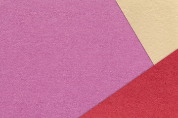 Fototapeta premium Magenta textured paper background with red beige triangular corners and copy space. Template for presentation, banner