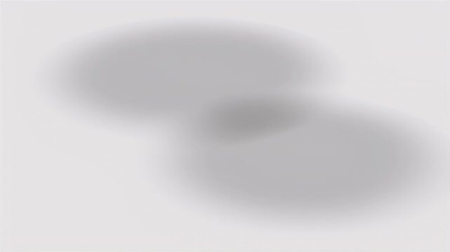 Abstract blurred composition of two overlapping spheres against a pale gray background
