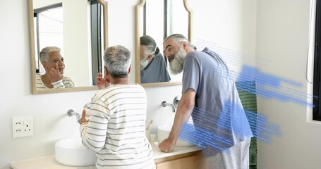 Touching cheek, striped-top woman and blue-T-shirt man leaning at bathroom double vanity, overlay