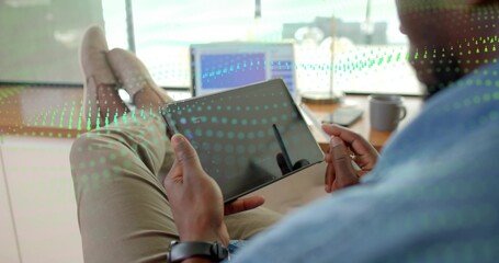 Leaning right worker in blue shirt at office, holding tablet, stylus, green overlay, copy space