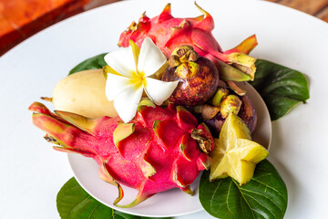 Set of tropical fruit on white wooden table , top view. Pitaya fruit, lychee, mangosteen, mango