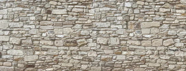 Fotobehang Stenen muur Old stone wall texture background presenting rough masonry pattern  © Kornienko Alexandr