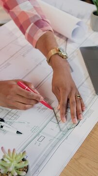 Building industry concept where unknown confident skilled man-architect in vest drawing lines on blueprint using pen and protractor on drafting table in design workroom