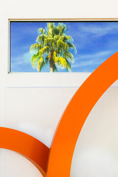 Palm Springs, California, USA. Mid century design and reflection of palm tree in window. 