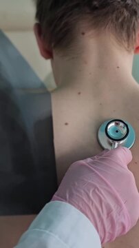 Child receives medical check-up with stethoscope and X-ray background