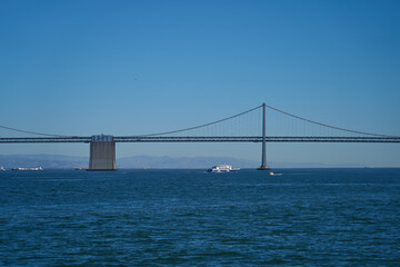 San Francisco, USA - October 28, 2025 - Iconic Bay Bridge spans across the deep blue water under a clear sky