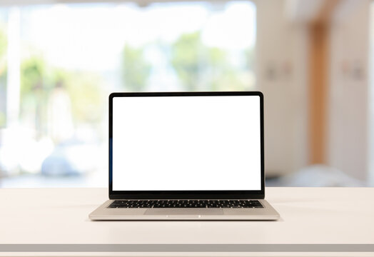 close up isolated on blank white screen display of laptop computer on table inside office room for add content of design banner , website or template or online shopping e-commerce concept