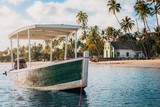 Carneiros, PE, Brazil - November 1st 2025: Fishing Boat in front of Saint Benedict Chapel at Carneiros Beach in Pernambuco Brazil
