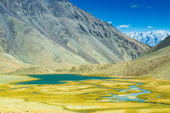 View of lake and river with snowy mountain peak at Chang La , southern pass, a high mountain pass in Ladakh in the Greater Himalaya between Leh and the Shyok River valley. Leh, Ladakh, India.
