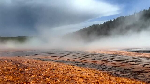 yellowstone national park hot water red orange midway grand prismatic basin geyser steam rising wyoming united states