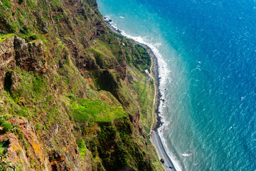 Fototapeta premium Vertical aerial view of a massive sea cliff and turquoise ocean.