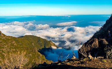 Fototapeta premium Breathtaking view of white clouds filling a mountain valley.
