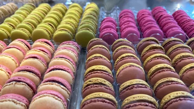 neatly arranged macarons in bright colors, highlighting sweet textures, artisanal quality and eye catching confectionery visuals ideal for food and commercial footage