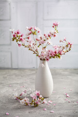 Vase with cherry blossoms on kitchen table