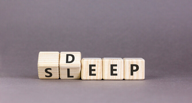 Deep sleep symbol. Concept words Deep sleep on beautiful wooden cubes. Beautiful grey table grey background. Healthy lifestyle, medical and deep sleep concept. Copy space.