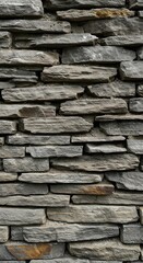 Obraz premium A detailed close-up texture shot of a rustic, weathered dry-stacked stone wall featuring rugged gray and brown sedimentary rocks ,brickwork ,vintage ,neutral