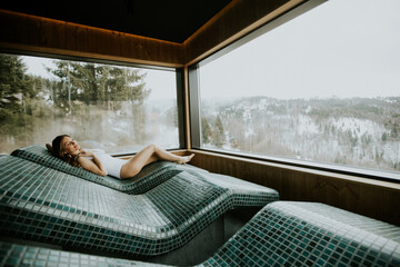 Enjoying serenity on a warm stone bed in a tranquil spa with beautiful mountain views
