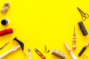 Tools for repair shoes. Hammer, awl, knife, thread on table, top view