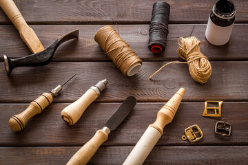 Leather craft work tools flat lay. Tailor or shoemaker on workplace, top view