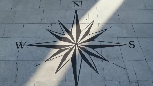 Abstract Compass Rose Pattern Etched into Gray Concrete Surface, Minimalist Geometric Design, Directional Symbol, Navigation Concept.