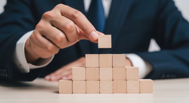 A professional building a block structure with careful precision and strategy.