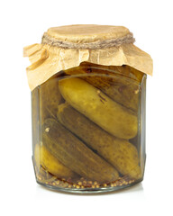 Homemade pickled cucumbers in a glass jar isolated on a white background.